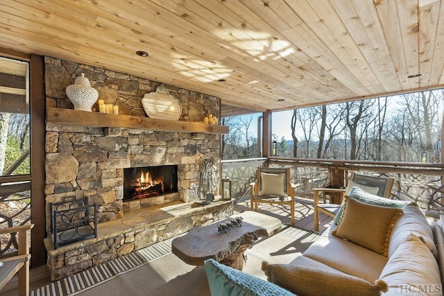 sunroom / solarium with wood ceiling, a fireplace, and a wealth of natural light