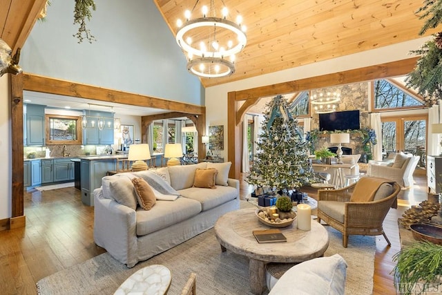 living room featuring hardwood / wood-style flooring, plenty of natural light, a chandelier, and french doors