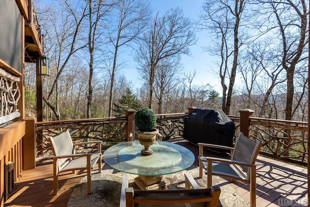 wooden deck featuring outdoor dining space and area for grilling