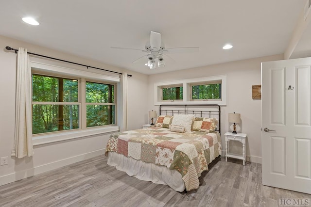 bedroom with light hardwood / wood-style floors and ceiling fan