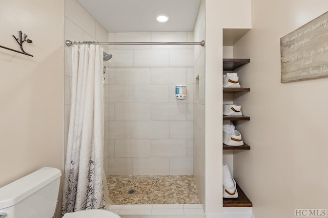 bathroom featuring walk in shower and toilet