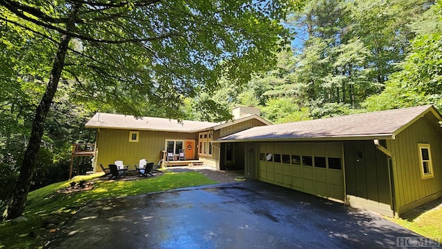 single story home featuring a garage and a deck