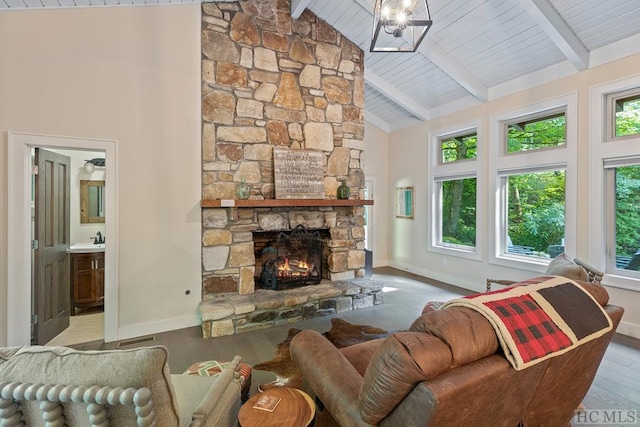 living room with beamed ceiling, a fireplace, high vaulted ceiling, and light wood-type flooring