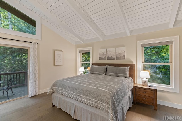 bedroom featuring multiple windows, access to exterior, hardwood / wood-style flooring, and beamed ceiling