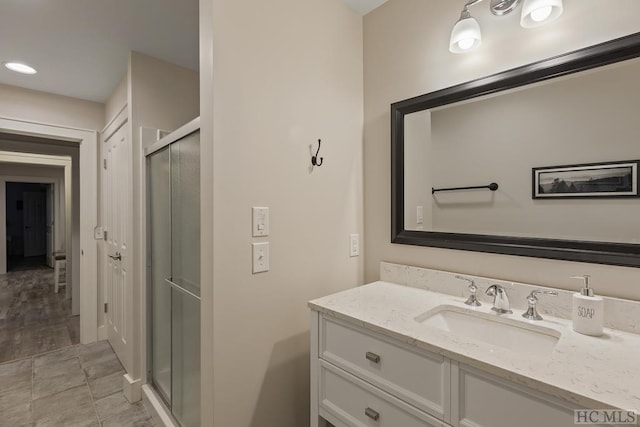 bathroom featuring vanity and a shower with shower door