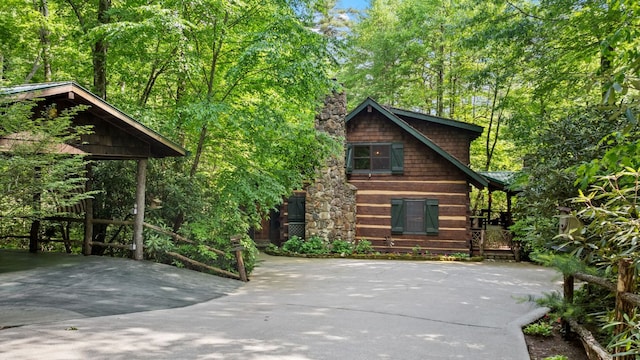 671 Walkingstick Rd, Highlands, NC 28741 - chalet / cabin with a chimney and concrete driveway