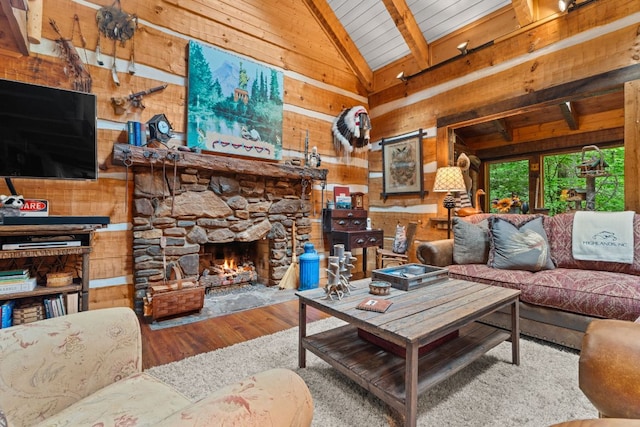 671 Walkingstick Rd, Highlands, NC 28741 - living area with wooden walls, lofted ceiling, a fireplace, and wood finished floors
