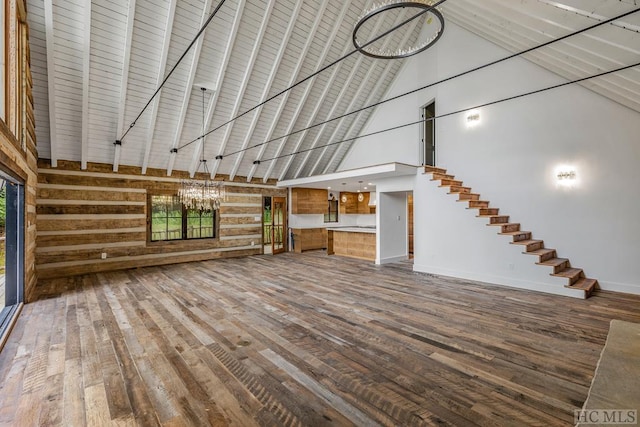 unfurnished living room with high vaulted ceiling and hardwood / wood-style floors