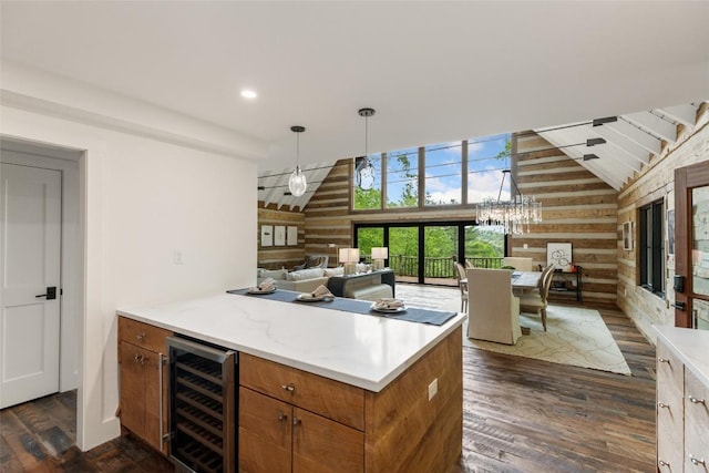 453 Bright Mountain Rd, Cullowhee, NC 28723 - kitchen featuring beverage cooler, wood walls, brown cabinets, dark wood-style flooring, and a peninsula