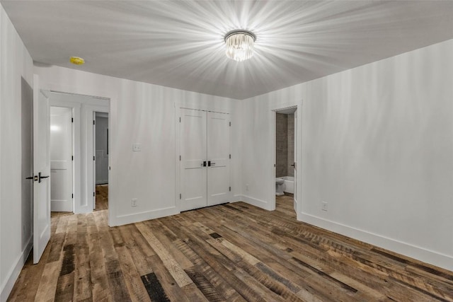 453 Bright Mountain Rd, Cullowhee, NC 28723 - unfurnished bedroom with wood finished floors, a closet, ensuite bathroom, and a chandelier
