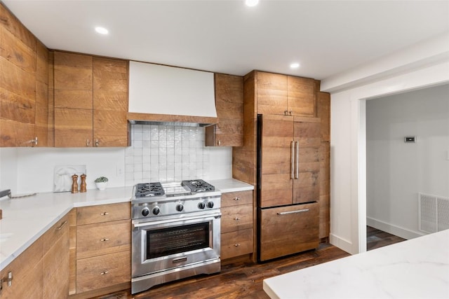 453 Bright Mountain Rd, Cullowhee, NC 28723 - kitchen featuring high end appliances, brown cabinetry, tasteful backsplash, dark wood-style flooring, and custom exhaust hood