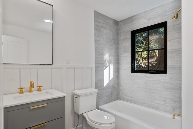 bathroom featuring a washtub, vanity, and toilet