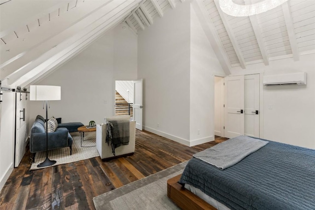 453 Bright Mountain Rd, Cullowhee, NC 28723 - bedroom featuring a wall mounted AC, wood finished floors, a barn door, high vaulted ceiling, and baseboards