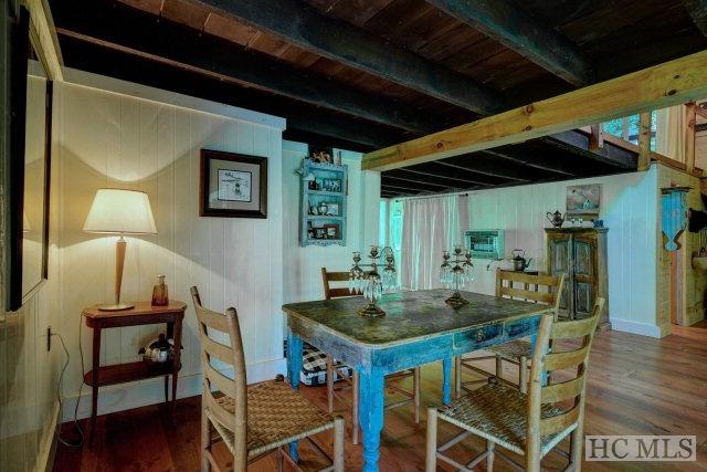 interior space featuring beam ceiling, dark hardwood / wood-style flooring, and wooden ceiling