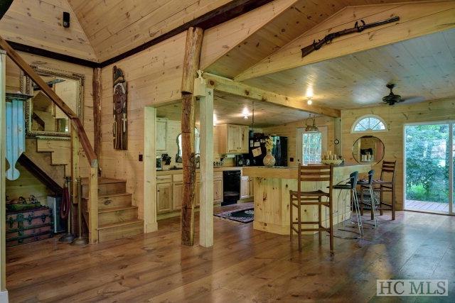 interior space featuring dark hardwood / wood-style flooring, plenty of natural light, wood ceiling, and vaulted ceiling