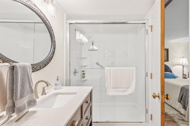 ensuite bathroom featuring vanity, wood finished floors, ensuite bath, ornamental molding, and a shower stall