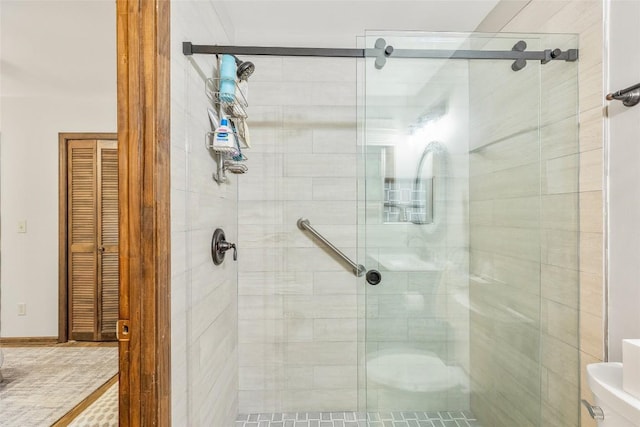 full bathroom featuring a shower stall and toilet