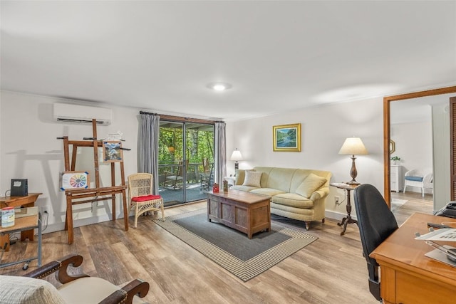 living area with baseboards, light wood-style flooring, and a wall mounted AC