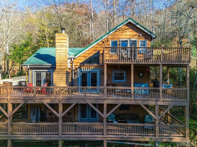 back of house with a wooden deck