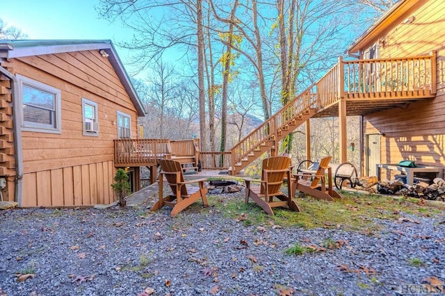 view of yard featuring a deck and a fire pit