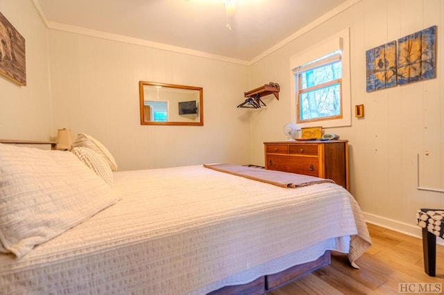 bedroom with hardwood / wood-style floors and crown molding