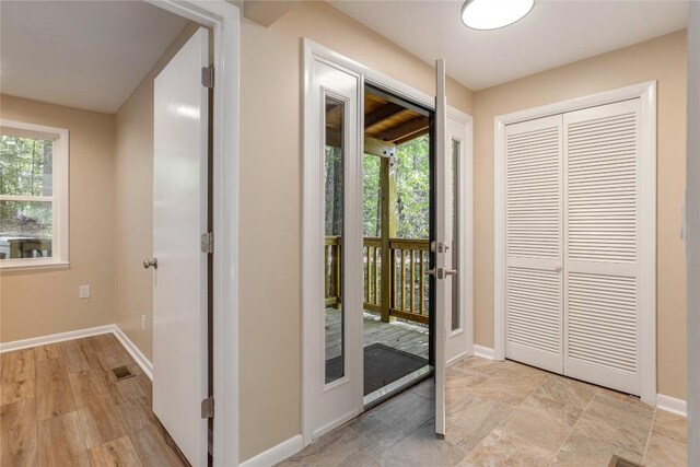 19 Indian Falls Way, Lake Toxaway, NC 28747 - unfurnished living room with baseboards, a stone fireplace, wooden walls, and high vaulted ceiling
