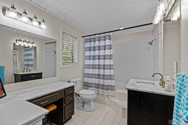 bathroom with a shower with curtain, vanity, tile patterned floors, and toilet