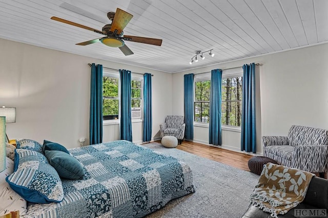 bedroom with multiple windows, wood-type flooring, wooden ceiling, and ceiling fan