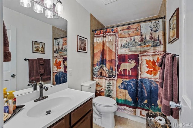 bathroom featuring tile patterned flooring, vanity, a shower with shower curtain, and toilet