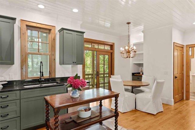 60 Glassy Vw, Cashiers, NC 28717 - kitchen featuring a sink, dark countertops, light wood-type flooring, a chandelier, and crown molding