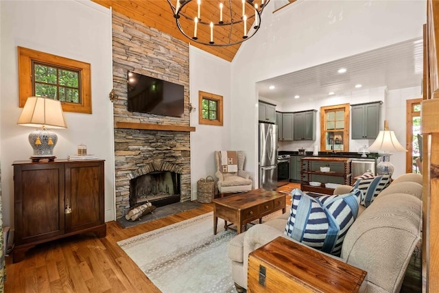 60 Glassy Vw, Cashiers, NC 28717 - living room with high vaulted ceiling, wood finished floors, a chandelier, and a fireplace