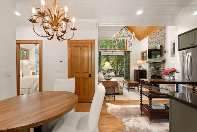 60 Glassy Vw, Cashiers, NC 28717 - dining space with a chandelier, lofted ceiling, light wood-style flooring, wooden ceiling, and a stone fireplace