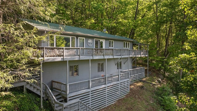 233 Strawberry Hill Rd, Cullowhee, NC 28723 - rear view of house with stairs, a balcony, metal roof, and a view of trees