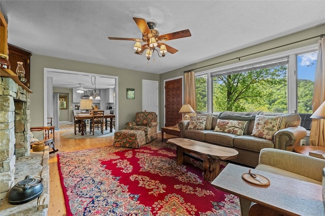 233 Strawberry Hill Rd, Cullowhee, NC 28723 - living area with a ceiling fan, wood finished floors, and a textured ceiling