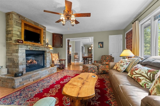 233 Strawberry Hill Rd, Cullowhee, NC 28723 - living area featuring wood finished floors, a ceiling fan, and a fireplace