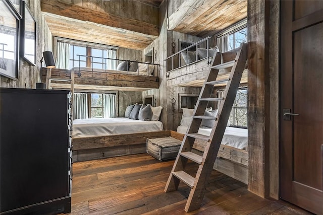 196 Stove Pipe Ct, Cashiers, NC 28717 - bedroom featuring wood walls, multiple windows, and hardwood / wood-style floors