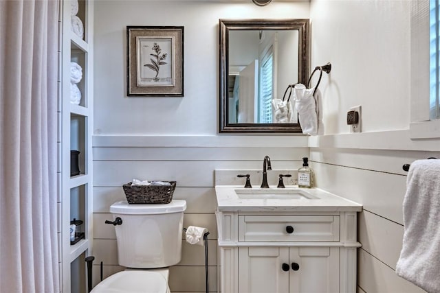 bathroom featuring toilet and vanity