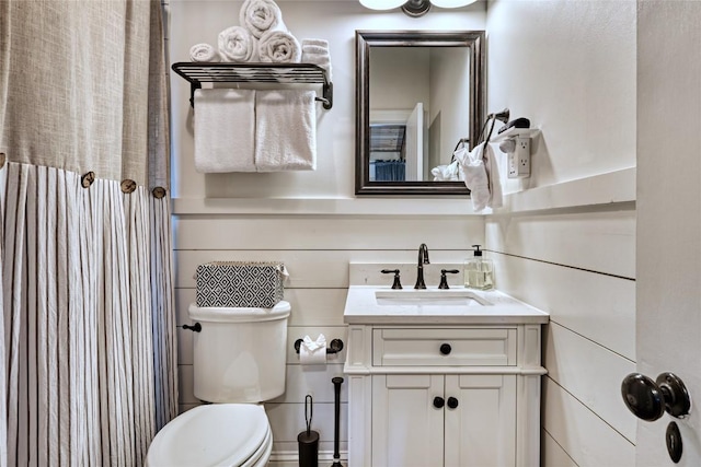 bathroom featuring vanity, toilet, and curtained shower