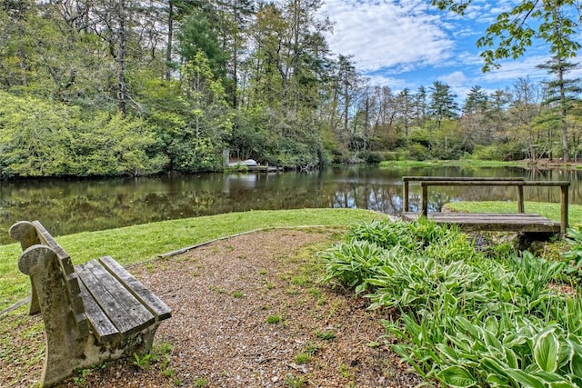 view of green lawn featuring a water view
