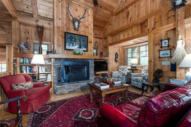 8 Par Path, Cashiers, NC 28717 - living area featuring wood walls, a wooden ceiling with exposed beams, healthy amount of natural light, a stone fireplace, and wood finished floors