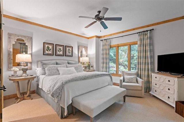 bedroom featuring light carpet, ceiling fan, baseboards, and ornamental molding