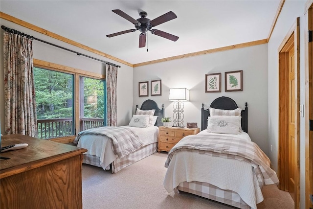 carpeted bedroom featuring access to exterior, a ceiling fan, and crown molding