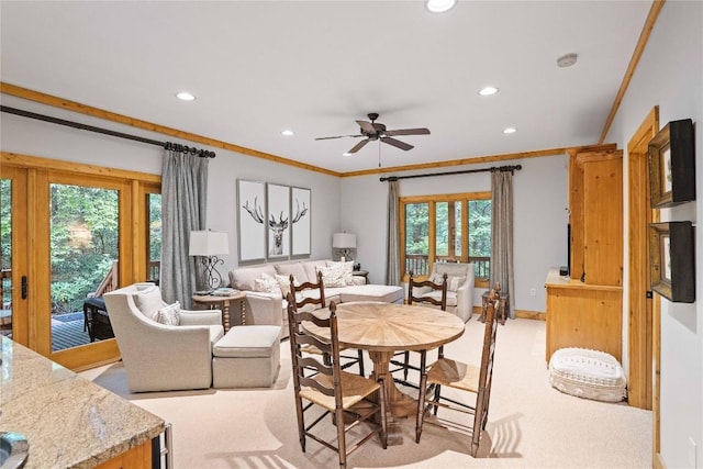 dining room with ceiling fan, recessed lighting, light colored carpet, and crown molding