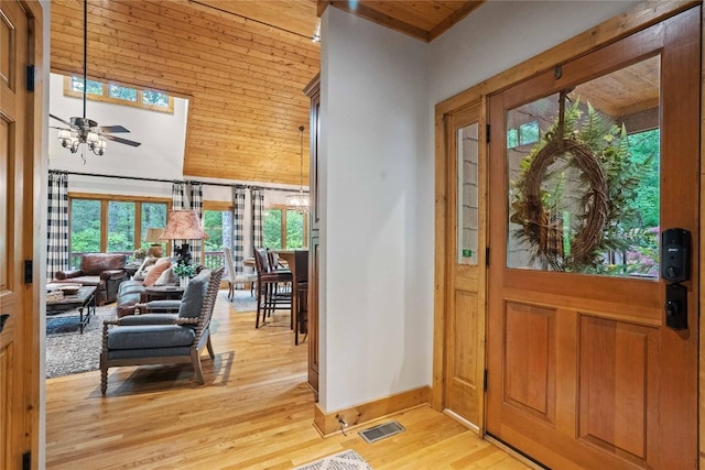 entrance foyer featuring ceiling fan, a high ceiling, visible vents, baseboards, and light wood finished floors