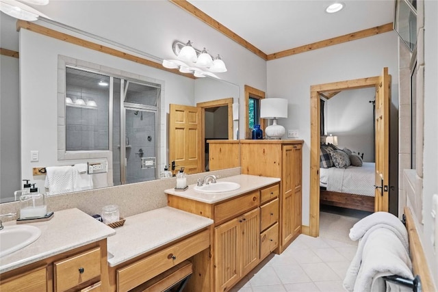 bathroom with a sink, crown molding, a shower stall, and ensuite bathroom