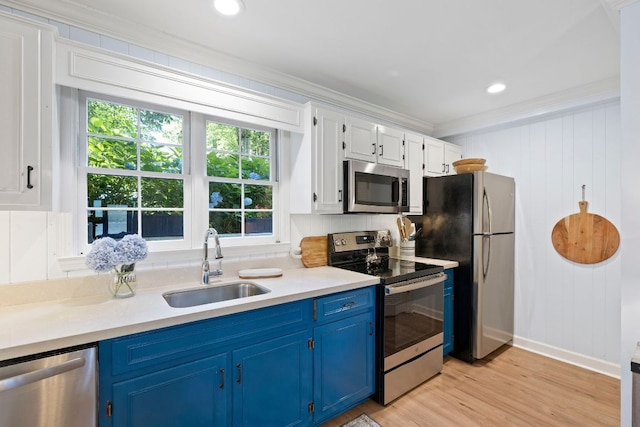 28 Toxaway Pt Unit 7, Lake Toxaway, NC 28747 - kitchen featuring stainless steel appliances, blue cabinetry, ornamental molding, light countertops, and light wood-style floors