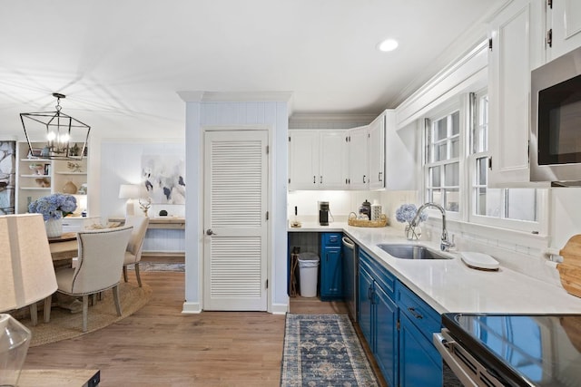 28 Toxaway Pt Unit 7, Lake Toxaway, NC 28747 - kitchen featuring blue cabinets, stainless steel appliances, crown molding, a chandelier, and white cabinets