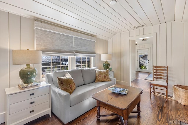 living room with dark hardwood / wood-style flooring, lofted ceiling, wood ceiling, and wood walls