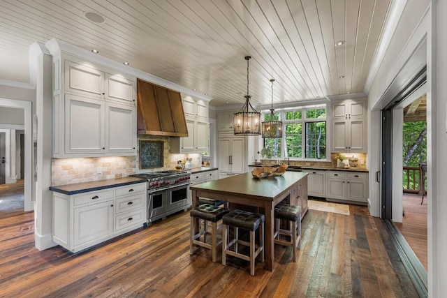 547 Burl Ln, Cashiers, NC 28717 - kitchen featuring double oven range, dark countertops, premium range hood, a chandelier, and crown molding