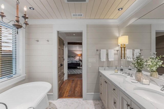 547 Burl Ln, Cashiers, NC 28717 - bathroom with a freestanding bath, ensuite bathroom, healthy amount of natural light, double vanity, and crown molding